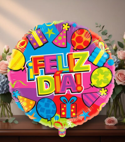 Globo redondo de colores brillantes con texto ¡Feliz día! y dibujos de regalos, globos y sombreros de fiesta, frente a un jarrón con ramos de flores sobre una mesa de madera