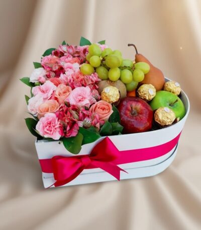 Arreglo AMOS en caja corazón con rosas rosadas, alstroemerias, uvas, manzanas, pera y chocolates Ferrero Rocher, ideal para r