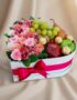 Arreglo AMOS en caja corazón con rosas rosadas, alstroemerias, uvas, manzanas, pera y chocolates Ferrero Rocher, ideal para r