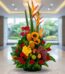 Arreglo floral premium con rosas rojas, girasoles, aves del paraíso, frutas durio, uvas y manzanas, sobre mármol en un lobby