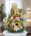 Arreglo floral exótico y vibrante con frutas, lirios, girasoles y aves del paraíso sobre una base de mármol en un entorno ele