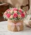 Arreglo floral GIADA con 12 rosas frescas rosadas y crema en una caja redonda de cartón con lazo rosa, ideal para regalo.