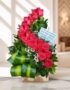 Arreglo floral premium con rosas rojas voluta, follaje verde y detalles blancos, sobre una superficie de mármol en un entorno