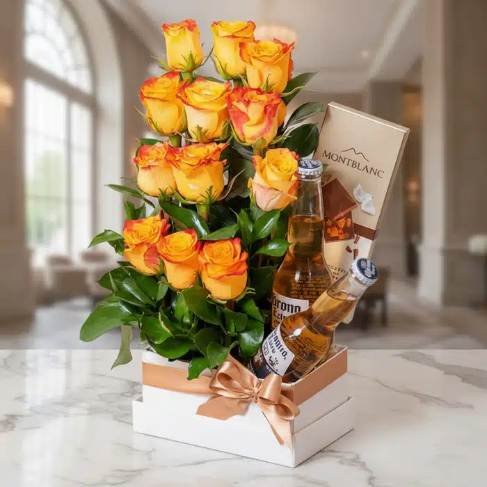 Arreglo Floral Zeus: Rosas Amarillas, Cervezas y Chocolates Premium Arreglo floral Zeus con rosas amarillas y naranjas, dos cervezas Corona y chocolates Montblanc en un elegante fondo de lobby