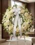 Corona fúnebre Almudena con rosas blancas, lirios y hortensias, lazo de satén, en sala de velación premium con luz natural su